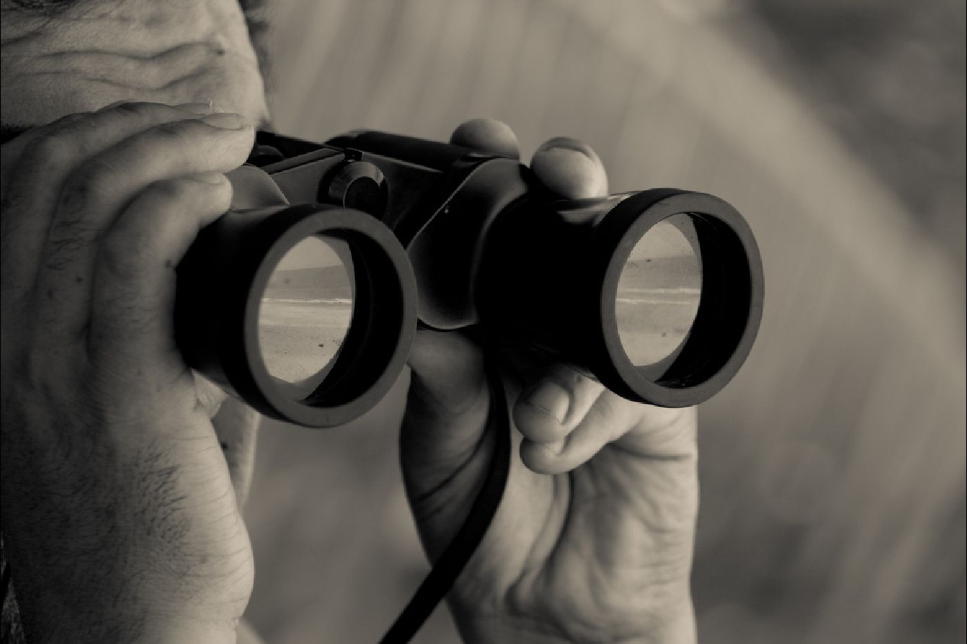 Man looking through binoculars